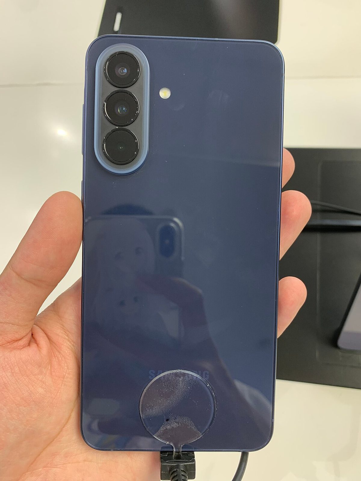 Samsung Galaxy A57 5G in navy, rear view with triple camera